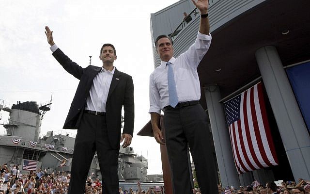 Republican presidential candidate, former Massachusetts Gov. Mitt Romney, right, and vice presidential candidate Wisconsin Rep. Paul Ryan, R-Wis., wave at the crowd during a campaign event, Saturday. (photo credit: AP)