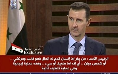 Syrian President Bashar Assad appears on Addounia TV, August 29 (photo credit: AP)