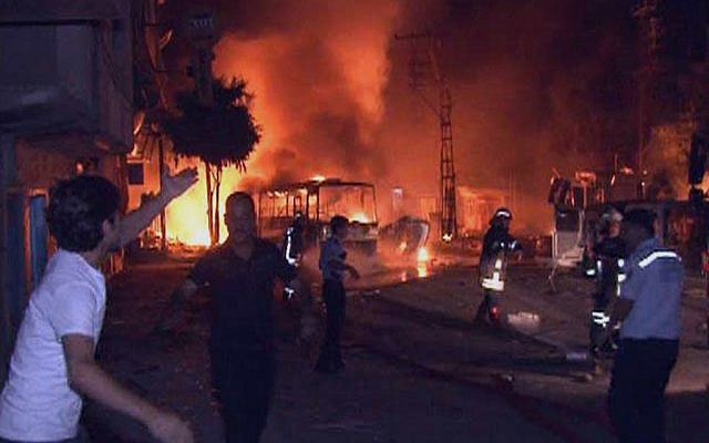 Firefighters and police officers seen after an explosion near a police station in southern Turkish city of Gaziantep, Turkey, in August, 2012. (photo credit: HA/AP)