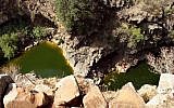 People swim in two freshwater pools that rest under a large waterfall of the Nahal Zavitan. (Phil Sussman/Flash90)