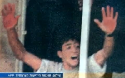 Aziz Salha waving his bloody hands after the lynch of 2 IDF reservists in Ramallah in 2000 (photo credit: screen capture, YouTube) Aziz Salha waving his bloody hands after the lynch of 2 IDF reservists in Ramallah in 2000 (photo credit: screen capture, YouTube)