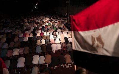 Gaza residents pray outside the Egyptian embassy in solidarity with Egypt following the attack (photo credit: Wissam Nassar/Flash90)