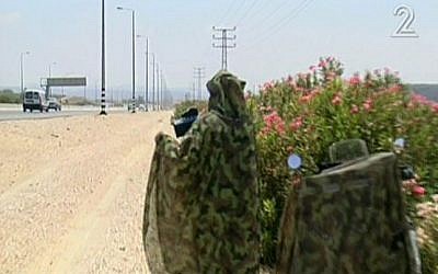 A camouflaged traffic police officer on the side of the highway. (photo credit: Image capture from Channel 2)