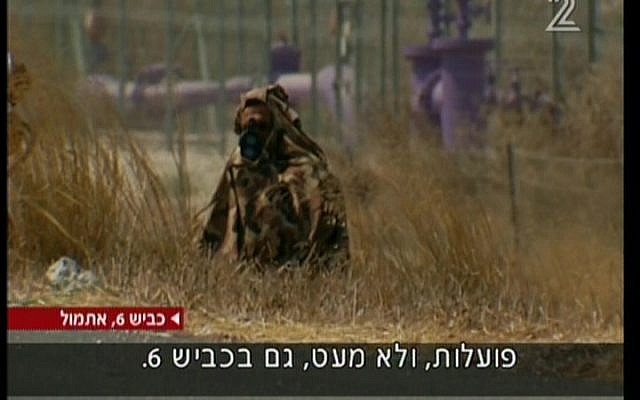 A camouflaged traffic police officer encamped on the side of the highway. (photo credit: Image capture from Channel 2)