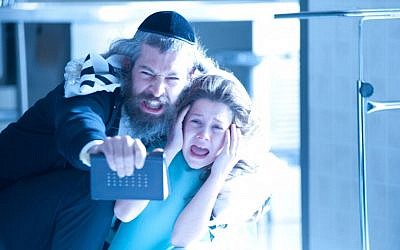 A rabbi's son (Matisyahu) attempts to exorcise a dybbuk, or malevolent spirit, from a young girl (Natasha Calis) in Hollywood thriller "The Possession" (Photo credit: courtesy of Lionsgate)