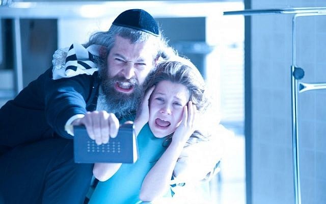 A rabbi's son (Matisyahu) attempts to exorcise a dybbuk, or malevolent spirit, from a young girl (Natasha Calis) in Hollywood thriller "The Possession" (Photo credit: courtesy of Lionsgate)