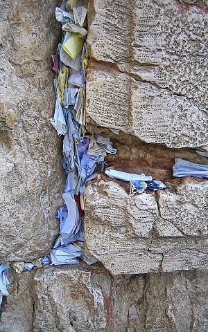 Prayers and notes in the cracks of the Western Wall (photo credit: CC-BY Yarin Kirchen/Wikipedia)