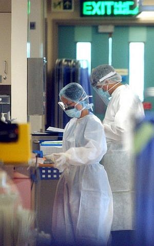 Health workers wearing protective gear in a Hong Kong hospital during the early days of the SARS epidemic in 2003 (photo credit: AP/Anat Givon)