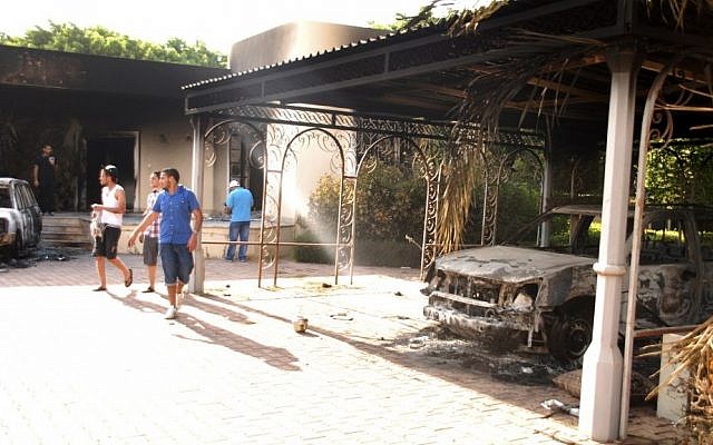 Libyans outside the burned-out American consulate in Libya on Wednesday, a day after it came under attack. (photo credit: AP/Ibrahim Alaguri) Libyans outside the burned-out American consulate in Libya on Wednesday, a day after it came under attack. (photo credit: AP/Ibrahim Alaguri)
