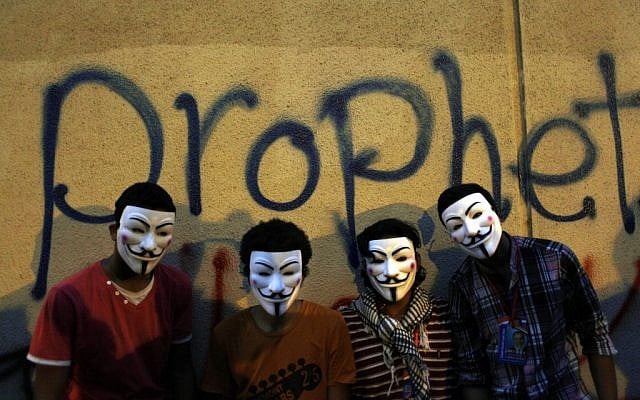 Egyptian protesters wearing Guy Fawkes masks pose for a photo in front of graffiti on a wall of the US Embassy during a protest in Cairo, Egypt, Tuesday, September 11, 2012 (photo credit: Nasser Nasser/AP) Egyptian protesters wearing Guy Fawkes masks pose for a photo in front of graffiti on a wall of the US Embassy during a protest in Cairo, Egypt, Tuesday, September 11, 2012 (photo credit: Nasser Nasser/AP)