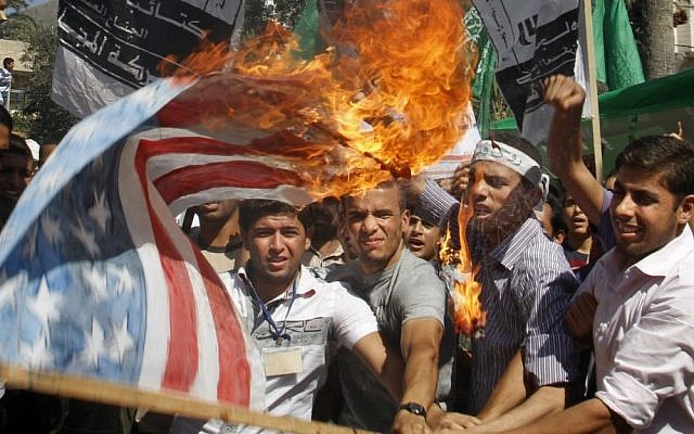 Palestinian Hamas supporters burn a US flag during a protest in Gaza City, Friday. (photo credit: AP) Palestinian Hamas supporters burn a US flag during a protest in Gaza City, Friday. (photo credit: AP)