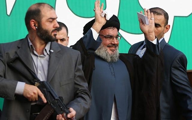 Hezbollah leader Hassan Nasrallah, center, escorted by his bodyguards, waves to a crowd of hundreds of thousands of supporters in Beirut, Lebanon in September, 2012. (Illustrative photo credit: AP/Hussein Malla) Hezbollah leader Hassan Nasrallah, center, escorted by his bodyguards, waves to a crowd of hundreds of thousands of supporters in Beirut, Lebanon in September, 2012. (Illustrative photo credit: AP/Hussein Malla)