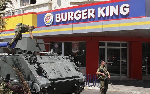 Lebanese soldiers guarding a Burger King in Sidon on Saturday, after two other fast food places in the country were torched. (photo credit: AP/Mohammed Zaatari)