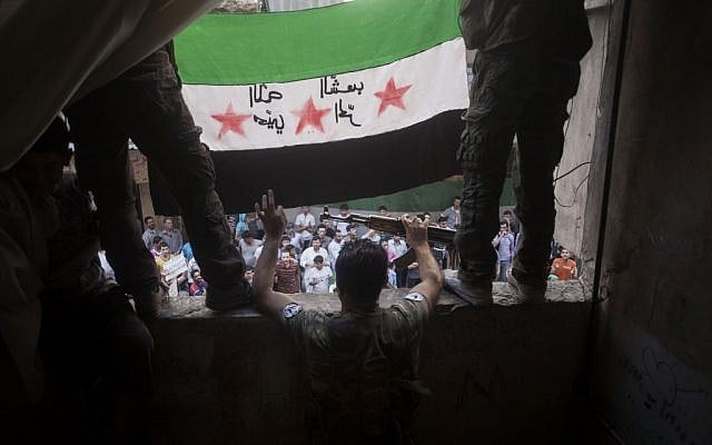 Members of the Free Syrian Army hold up a revolutionary flag in Aleppo, September 21 (photo credit: AP Photo/ Manu Brabo) Members of the Free Syrian Army hold up a revolutionary flag in Aleppo, September 21 (photo credit: AP Photo/ Manu Brabo)