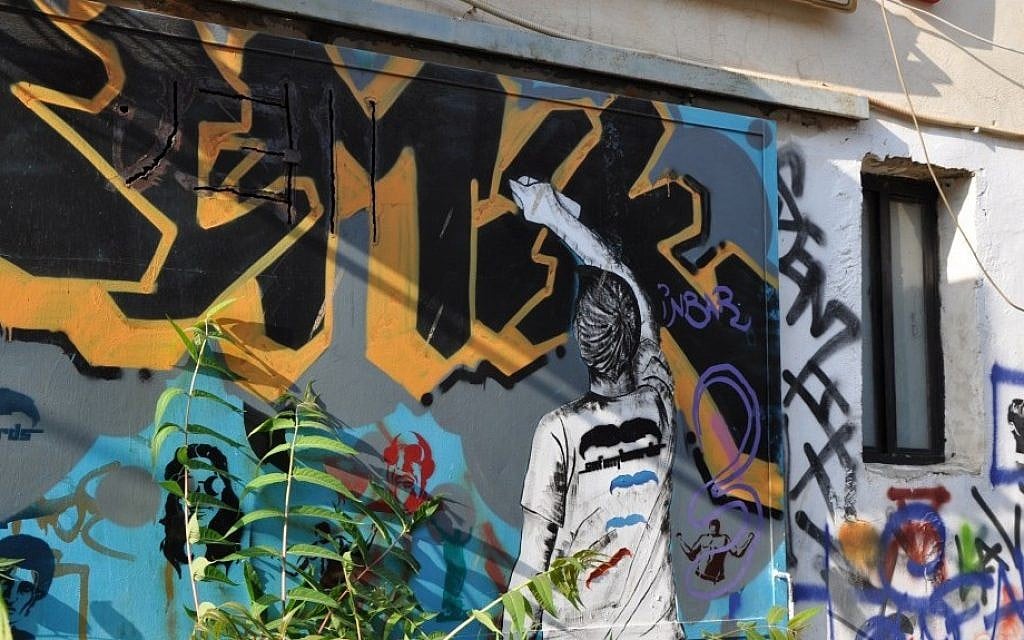 Street art, depicting an artist graffitiing, in south Tel aviv (photo credit: Michal Shmulovich/Times of Israel) Street art, depicting an artist graffitiing, in south Tel aviv (photo credit: Michal Shmulovich/Times of Israel)