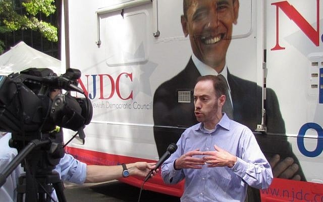 David Harris, the president of the National Jewish Democratic Council, speaking to a British journalist outside the NJDC bus in Charlotte N.C., Sept. 3 (photo credit: Ron Kampeas/JTA) David Harris, the president of the National Jewish Democratic Council, speaking to a British journalist outside the NJDC bus in Charlotte N.C., Sept. 3 (photo credit: Ron Kampeas/JTA)
