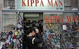 Trying on a yarmulke at Kippa Man on Jaffa Road in Jerusalem, December 7, 2006. (photo credit: Daniel Fleisch/Flash90)