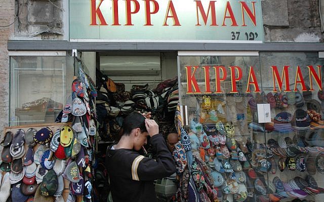 Trying on a yarmulke at Kippa Man on Jaffa Road in Jerusalem, December 7, 2006. (photo credit: Daniel Fleisch/Flash90)