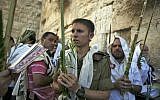 Illustrative: Jewish worshipers hold palm fronds, citron fruits and myrtle and willow branches during Sukkot 2009 (photo credit: Matanya Tausig/Flash90)