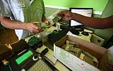 A patient purchases medicinal cannabis in Tel Aviv (photo credit: Abir Sultan/Flash90)