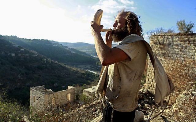 Blowing the shofar in Lifta, near Jerusalem (photo credit: Uri Lenz/Flash90)