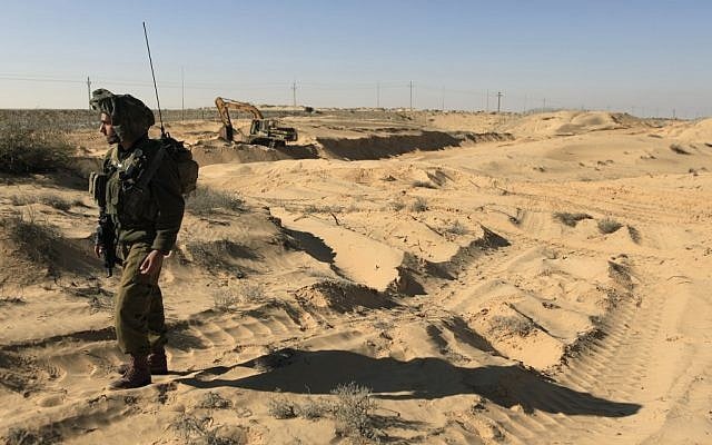 A soldier guards infrastructure work on the Israeli Egyptian border fence in 2011 (photo credit: Tsafrir Abayov/Flash90)