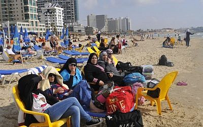 Young Arab women sit on the beach in Tel Aviv earlier this year (photo credit: Serge Attal/Flash90)