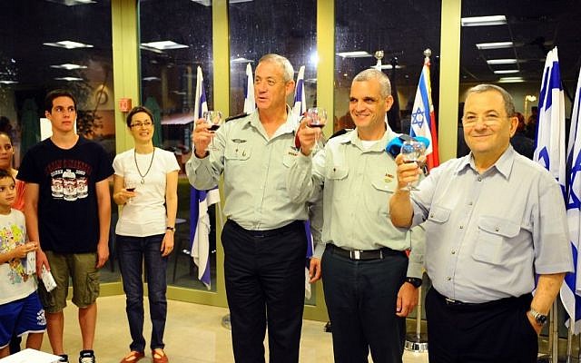 Yoav Har-Even (center) lifts a glass with IDF Chief of Staff Benny Gantz (left) and Defence Minister Ehud Barak after being promoted last week. Har-Even, whose family is at left, was named Tuesday to head the IDF’s Operations Division. (Photo credit: Ori Shifrin/IDF Spokesperson/Flash90) Yoav Har-Even (center) lifts a glass with IDF Chief of Staff Benny Gantz (left) and Defence Minister Ehud Barak after being promoted last week. Har-Even, whose family is at left, was named Tuesday to head the IDF’s Operations Division. (Photo credit: Ori Shifrin/IDF Spokesperson/Flash90)