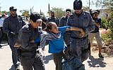 Protesters at the Jewish settlement of Migron being led away by Israeli border police on Sunday. (photo credit: Oren Nahshon/Flash90)