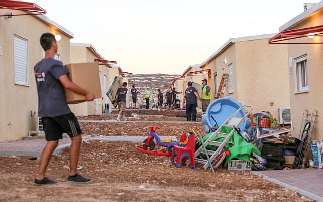 Movers help to evacuate the West Bank outpost of Migron last September (photo credit: Oren Nahshon/Flash90) Movers help to evacuate the West Bank outpost of Migron last September (photo credit: Oren Nahshon/Flash90)