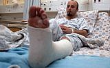 Ibrahim Abu Ta'a nursing a broken leg at Jerusalem's Sha'arei Tzedek Medical Center after being attacked by a group of Jews on September 6, 2012 (photo credit: Yoav Ari Dudkevitch/Flash90)