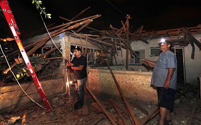 Men inspect damage to a house in Netivot that was hit by long-range Grad rocket fired from the Gaza Strip, Sunday Sep. 9 (photo credit: Tsafrir Abayov/Flash90) Men inspect damage to a house in Netivot that was hit by long-range Grad rocket fired from the Gaza Strip, Sunday Sep. 9 (photo credit: Tsafrir Abayov/Flash90)