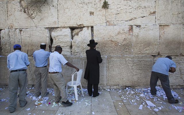 Workers remove thousands of notes and letters from the Western Wall ahead of the new year (photo credit: Yonatan Sindel/Flash90)