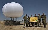 IDF soldiers on the Egyptian border with a sign wishing a 'Happy New Year' (photo credit: Tsafrir Abayov/Flash90)