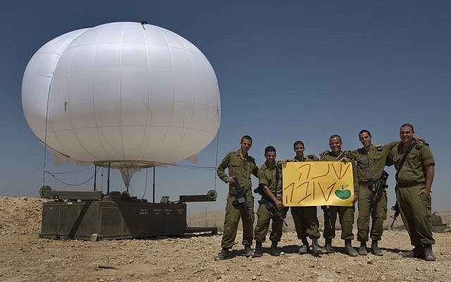IDF soldiers on the Egyptian border with a sign wishing a 'Happy New Year' (photo credit: Tsafrir Abayov/Flash90)