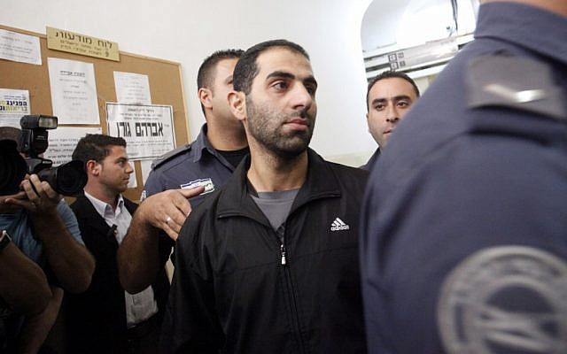 Suspected Hamas operative Louis Nasr al-Din of East Jerusalem is escorted by police into Jerusalem Magistrate's Court on Sunday. (photo credit: Miriam Alster/Flash90)