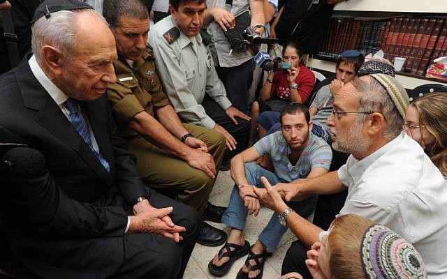 President Shimon Peres pays his respects to the family of Netanel Yahalomi, the soldier killed Friday afternoon in a shootout with terrorists on the Israeli-Egyptian border. (photo credit: Mark Nayman/GPO/Flash90)