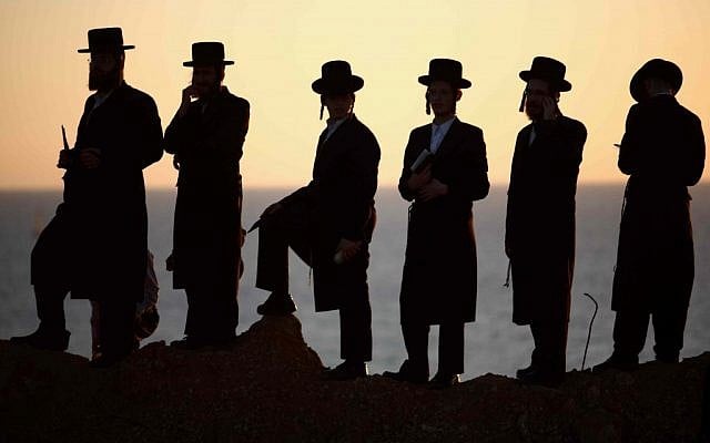 Israel prepares for a day of reflection.  Ultra-Orthodox men complete the Tashlich ("forgiveness") ceremony at the Mediterranean Sea on Monday (photo credit: Yehoshua Yosef/FLASH90)