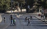 Israelis riding their bikes on the empty streets of Jerusalem on Yom Kippur. (Yonatan Sindel/Flash90)