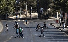 Israelis riding their bikes on the empty streets of Jerusalem on Yom Kippur. (Yonatan Sindel/Flash90)