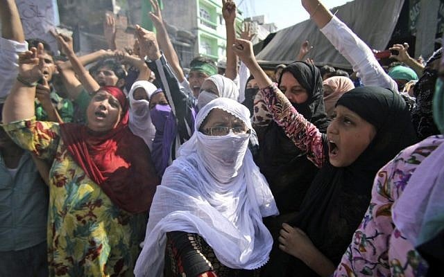 Indian Muslim women shout slogans against the US on Friday during a protest rally, one of many demonstrations around the world against perceived insults to the Prophet Muhammad. (photo credit: AP/Channi Anand)