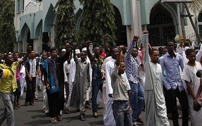 Muslim youths shout Allah Akbar, God is Great, after Friday prayers outside the Musa Mosque in the Majengo suburb of Mombasa, Kenya, Friday. (photo credit: AP)