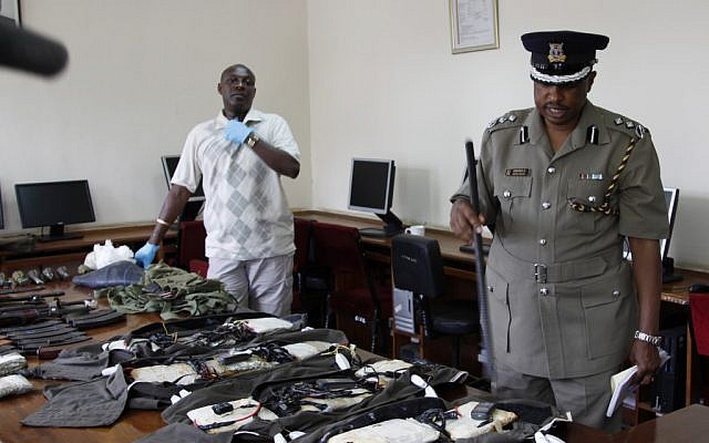 A Kenya Police spokesman displays arms and ammunition seized in Nairobi, Kenya, Friday, Sep. 14 (photo credit: AP/Khalil Senosi)