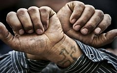 In this April 2006 file photo, Egyptian Copts cross their wrists in defiance outside the Saints Church in the Sidi Bishr district of Alexandria in Egypt. (photo credit: AP/Ben Curtis)