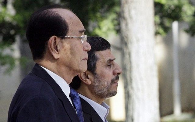 Iranian President Mahmoud Ahmadinejad, right, and president of the Presidium of North Korea's Supreme People's Assembly Kim Yong-nam, listen to their national anthems during an official welcoming ceremony in Tehran, Iran, Saturday. (photo credit: AP)