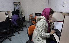Iranian women use computers at an Internet cafe in central Tehran. (photo credit: AP/Vahid Salemi)