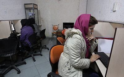 Iranian women use computers at an Internet cafe in central Tehran. (photo credit: AP/Vahid Salemi)