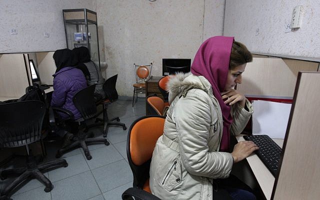 Iranian women use computers at an Internet cafe in central Tehran. (photo credit: AP/Vahid Salemi)