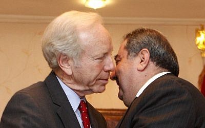 US Senator Joe Lieberman, left, greets Iraqi Foreign Minister Hoshyar Zebari in Baghdad in 2012 (photo credit: AP/Karim Kadim)