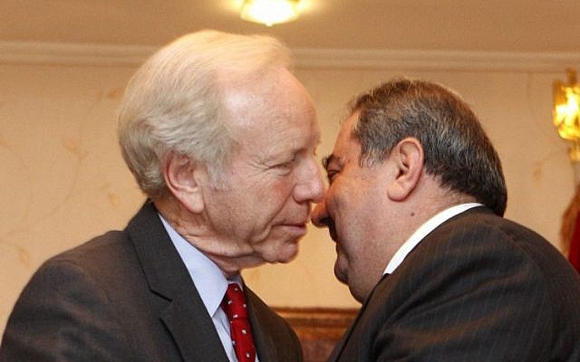 US Senator Joe Lieberman, left, greets Iraqi Foreign Minister Hoshyar Zebari in Baghdad in 2012 (photo credit: AP/Karim Kadim)